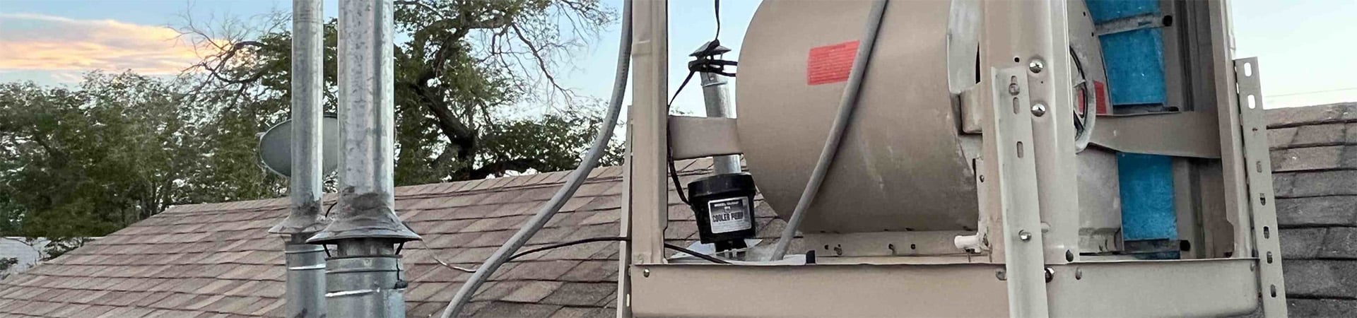 Swamp cooler winterization being installed on a Loveland Colorado roof by Mountain Valley Plumbing