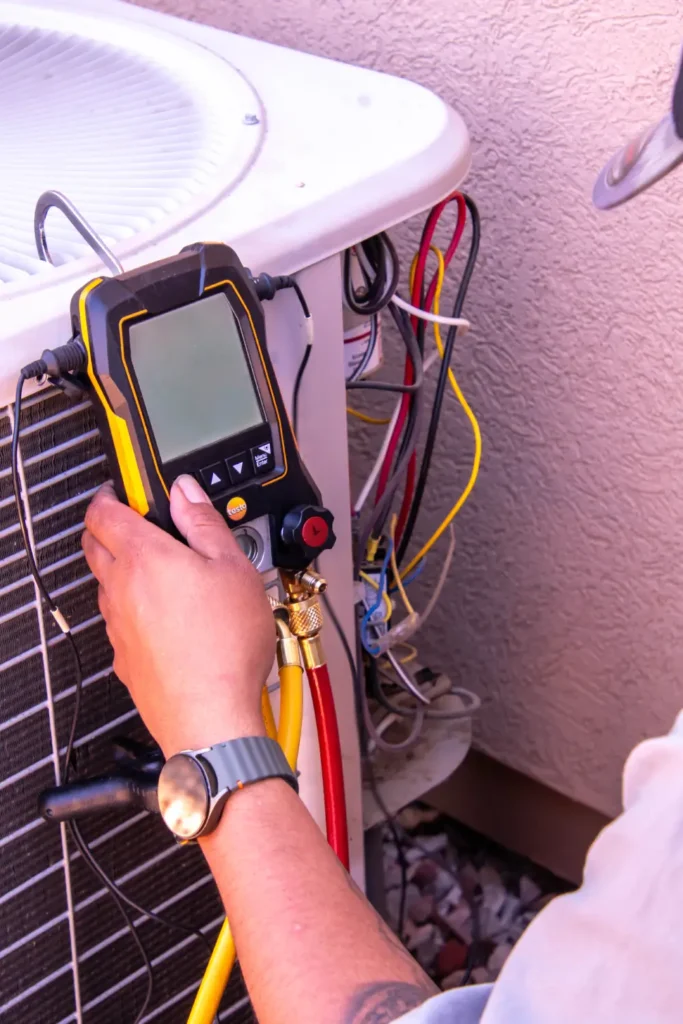 Technician inspecting an outdoor air conditioner unit